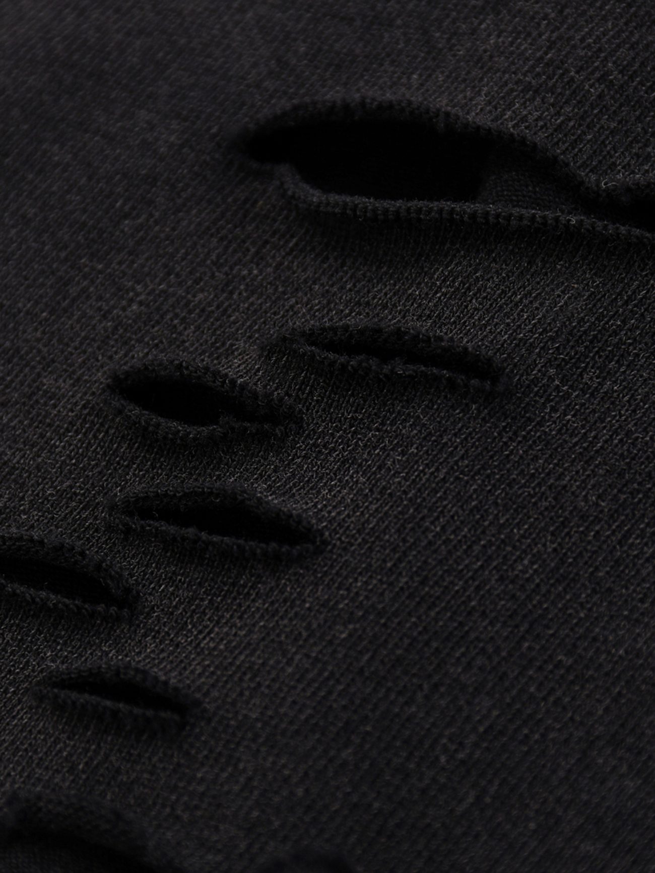 Close-up of the Fusion Snow Washed Raw-Hem T-Shirt in black, featuring horizontal rips and frayed edges for a textured, distressed look—ideal for those wanting affordable luxury with an edgy style.