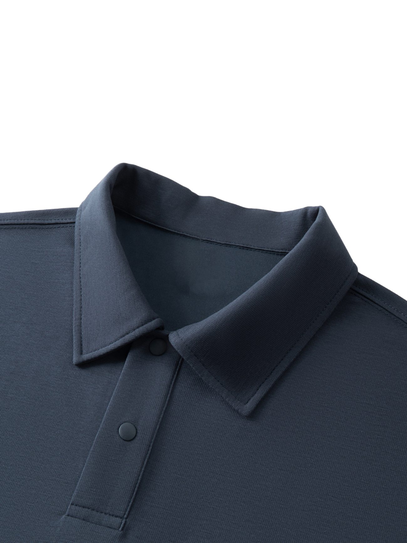 A close-up of the Fusion Drop Shoulder Short-Sleeve Polo in dark blue highlights its refined simplicity—no visible logos or patterns—capturing the essence of affordable luxury clothing with a button placket and collared design.