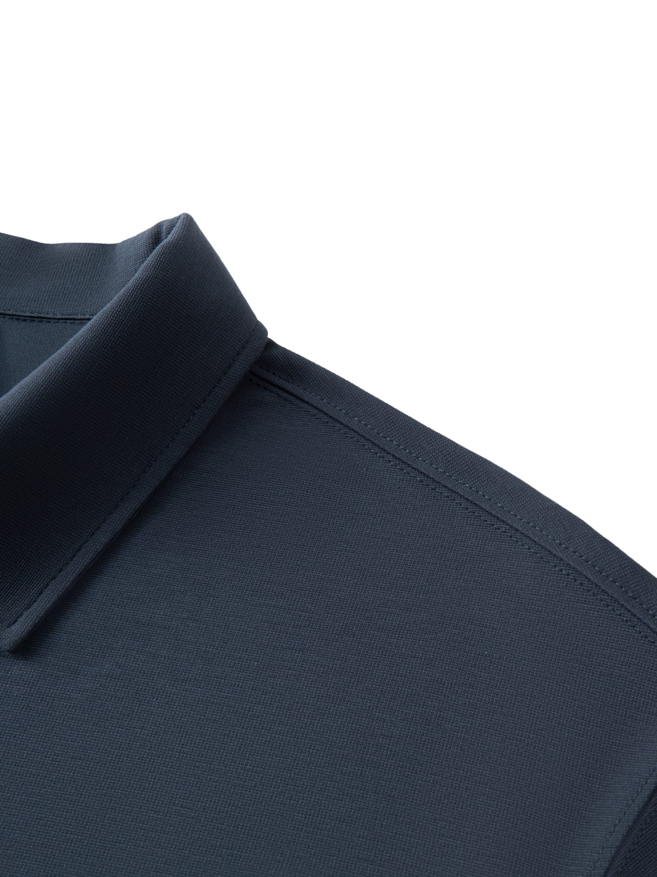 Close-up of the collar and shoulder on the Fusion Drop Shoulder Short-Sleeve Polo in dark navy, showing textured fabric and detailed stitching—a stylish example of affordable luxury.