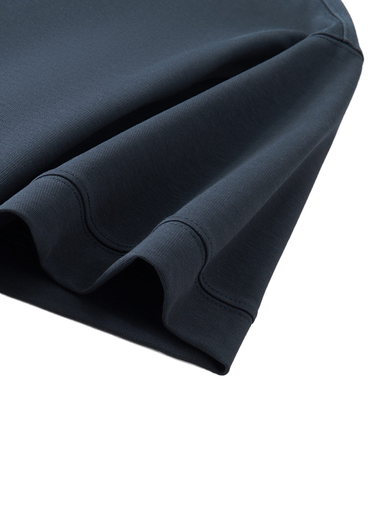 Close-up of the hem and sleeve of the Fusion Drop Shoulder Short-Sleeve Polo in dark navy blue, highlighting its fine stitching and smooth fabric texture—a perfect showcase of affordable luxury.
