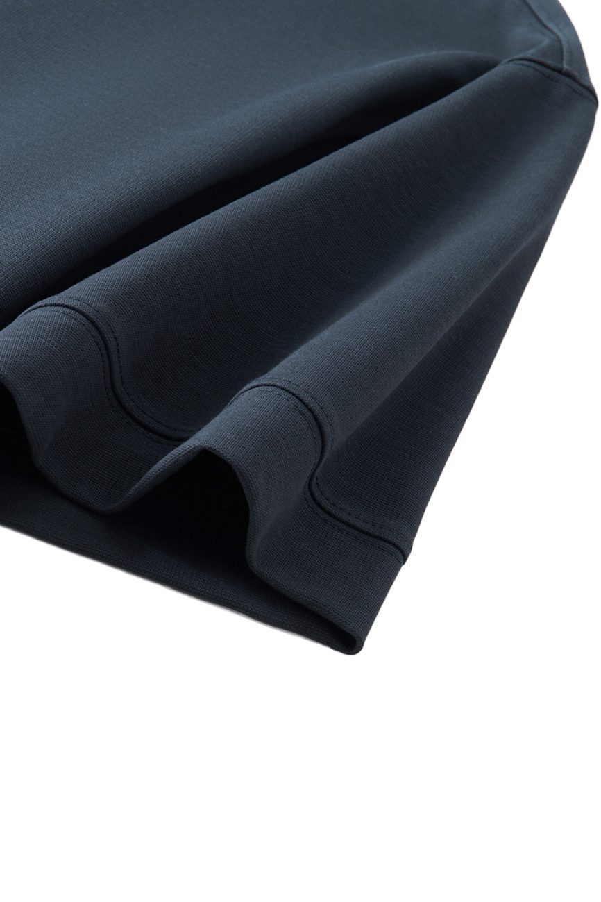 Close-up of the sleeve and hem of the FC&Co. - Drop Shoulder Short-Sleeve Polo, highlighting its smooth fabric and precise stitching—a sleek example of affordable luxury clothing.