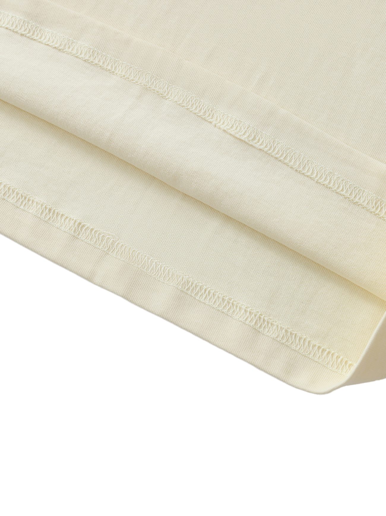 Close-up of the hem on the Crane Oversized Contrast-Stitched Cotton Tee in light beige, featuring neat double-stitched seams and a soft, smooth texture—a signature of affordable luxury. The fabric appears gently folded.