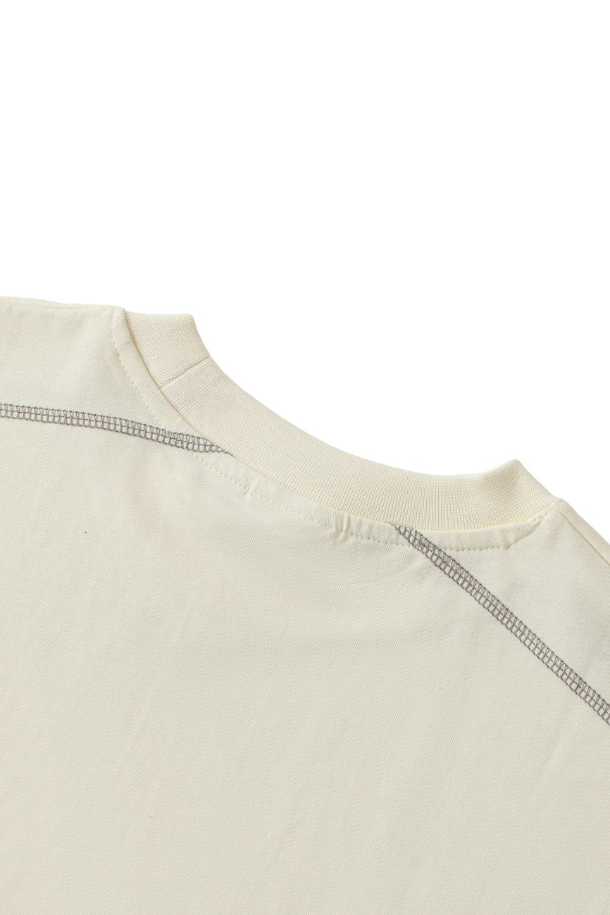Close-up of the upper back and neckline of the Crane - Oversized Contrast-Stitched Cotton Tee, highlighting its detailed stitching and ribbed collar—an elegant approach to affordable luxury, set against a white background.