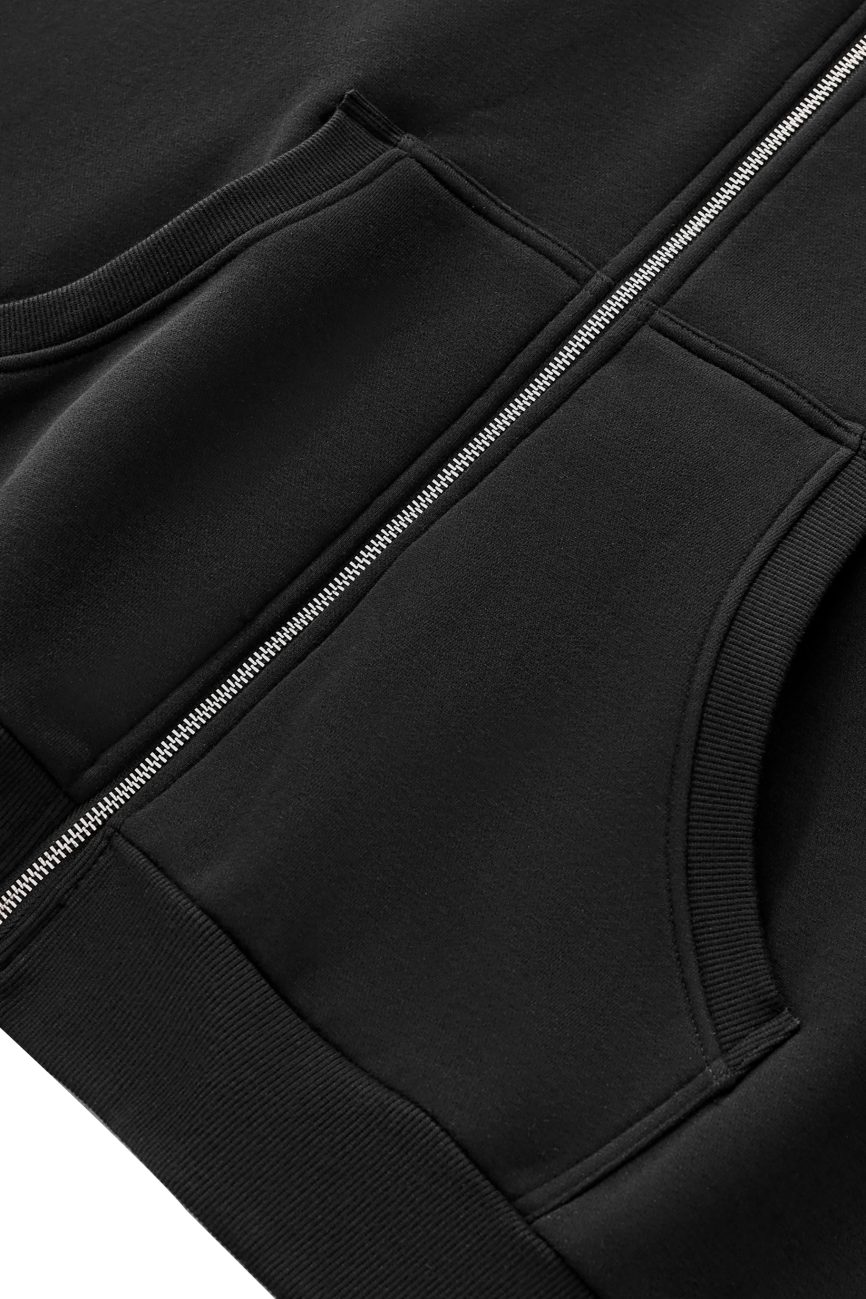 Close-up of the FC&Co. Fleeced Full-Zip Boxy Hoodie featuring a metal zipper and two ribbed front pockets on soft, smooth fabric—an affordable luxury essential.