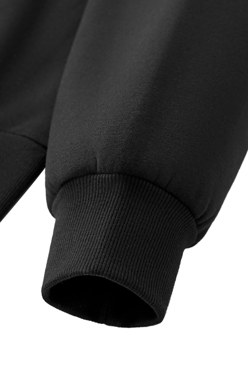 Close-up of the sleeve cuff of the FC&Co. Fleeced Full-Zip Boxy Hoodie, showcasing its ribbed knit texture and smooth, premium black fabric from our Affordable Luxury Clothing line.