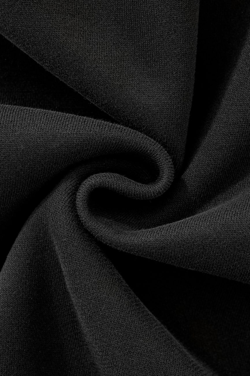 Close-up of the FC&Co. Fleeced Full-Zip Boxy Hoodie’s black fabric, twisted to highlight its soft texture and weave, showcasing the affordable luxury and comfy folds of this stylish hoodie.