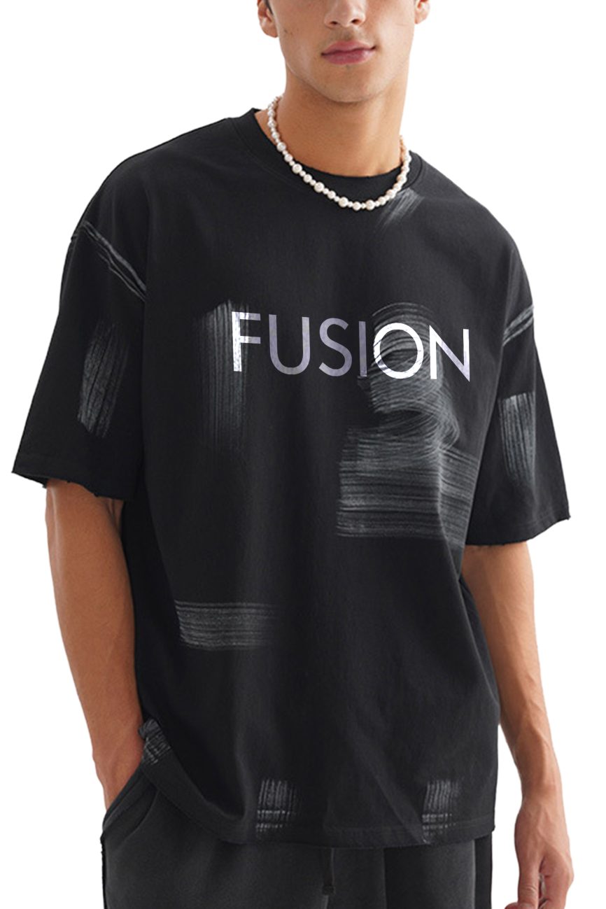 A person wearing the Hand Brushed T-shirt—an affordable luxury black tee with white brushstroke patterns and FUSION boldly printed across the chest—paired with a beaded necklace.